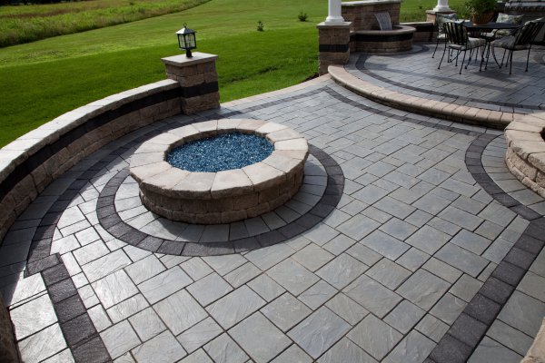 Patio with seat wall and fire pit by Unilock with Richcliff paver