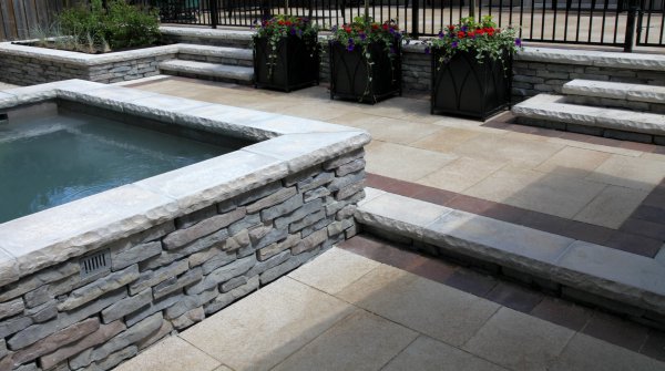 Umbriano paver patio with Rivercrest hot tub by Unilock